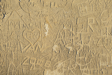 old wall scratched with names