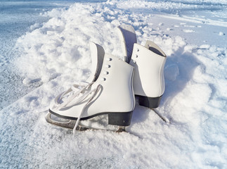 Women white skates. Abstract background on a winter sports theme