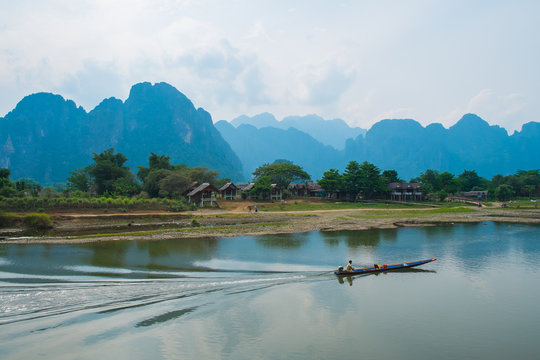 Boat on river on mountains background, Laos