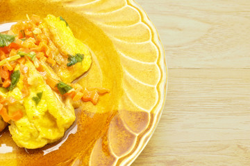 Yellow tofu fried carrot and celery on wood background