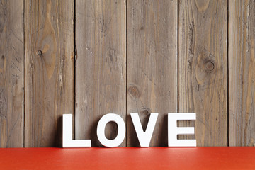 Love word on rustic wooden wall