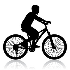 Obraz premium Schwarze Silhouette eines Fahrrad fahrenden Jungen