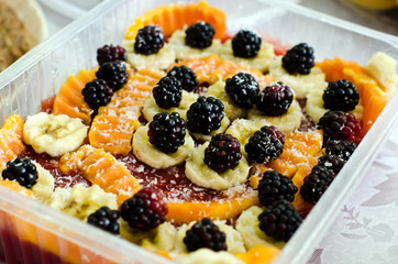 Vegetarian fruit pudding decorated with blackberries and banana.