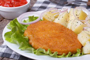 Schnitzel with young boiled potatoes closeup