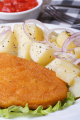 Schnitzel with young boiled potatoes vertical macro