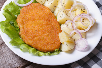 Schnitzel with young boiled potatoes top view
