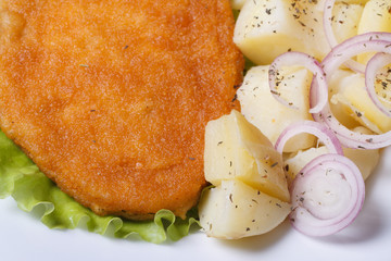 Schnitzel with new potatoes and onion top view
