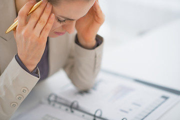 Stressed business woman working with documents in office