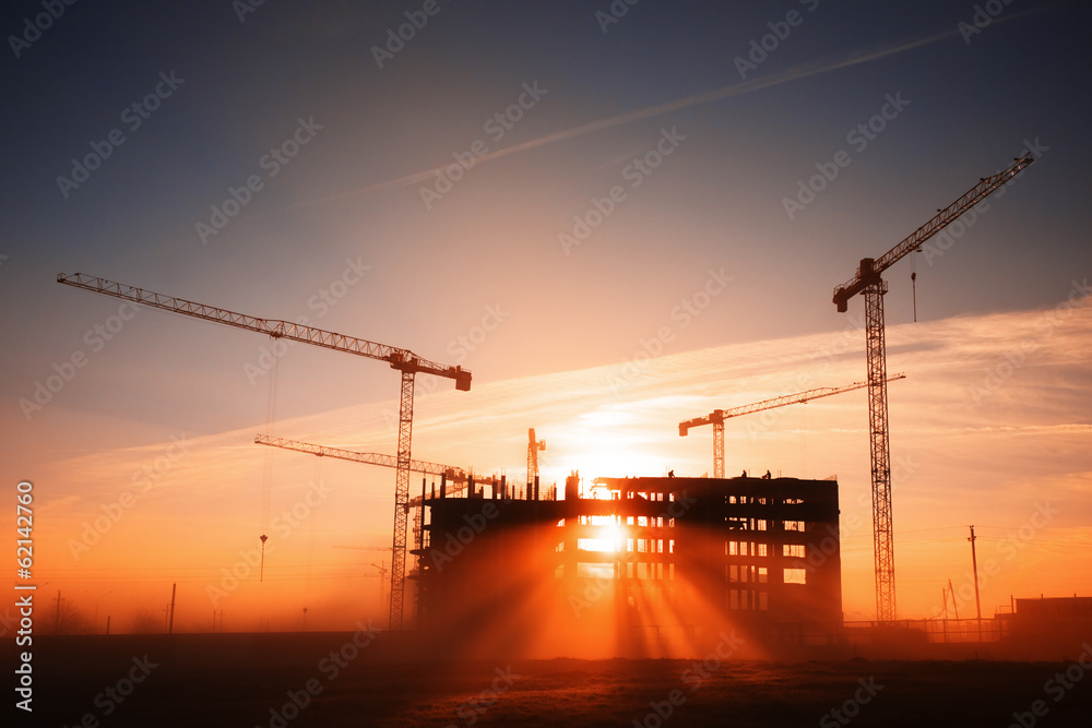 Wall mural tower cranes at construction site