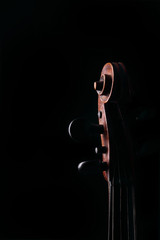 Detail of old violin on dark background