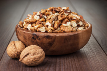 walnuts in the brown wooden bowl