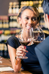Asian couple drinking red wine