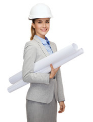 smiling architect in white helmet with blueprints