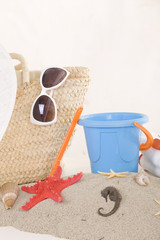 Fototapeta na wymiar beach bag with toys and sunglasses for the whole family