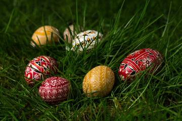 Colorful and beautifully designed eggs in the grass
