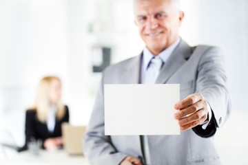 Senior businessman holding Blank business card