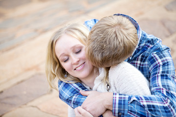 Young white male kissing his fiancé in her neck