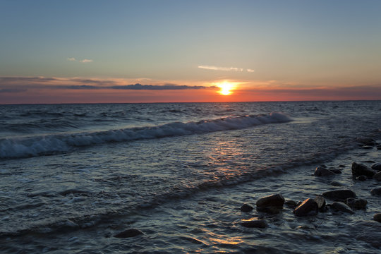 The sun is setting over the baltic sea
