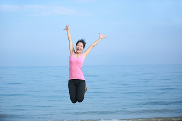 Obraz premium cheering woman jump at beach