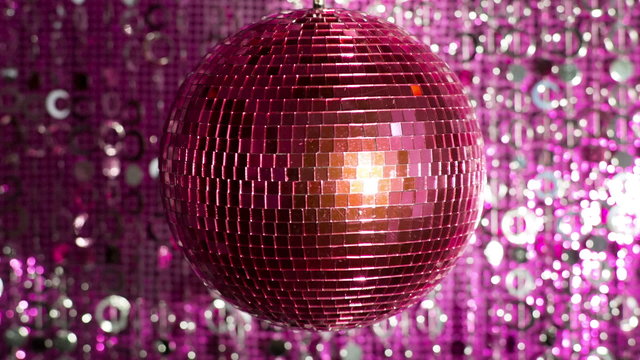 funky pink mirror ball spinning with patterns of light