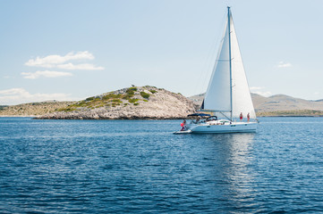 Yacht with white sail on the sea of islands,Kornati.Croatia
