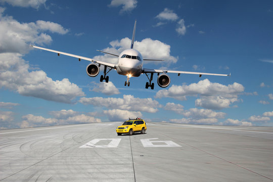 Treshold of runway with car and plane