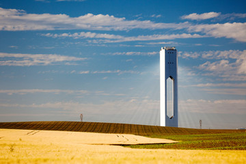 Solar Tower with rays  - thermo-solar power - blue sky and yello