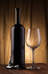 Wine bottle with glass on wooden table