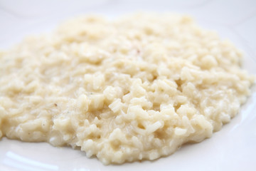 risotto dish with herbs on wood background