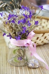 Still life with flowers in a transparent bank