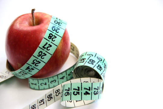 Fruit and measurement tape on the white background
