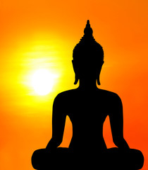 Buddha statue in the sunset background