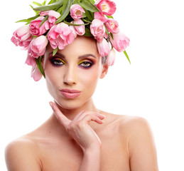 Portrait of a beautiful spring girl wearing flowers hat. Studio