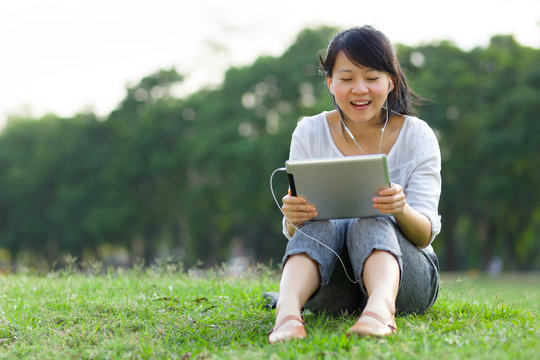 Woman talking via video call with digital tablet