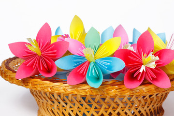 Many colored paper flowers in the basket