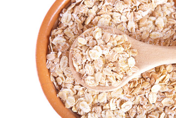 The oat flakes on a wooden spoon