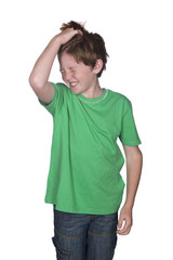 young boy scratching his head