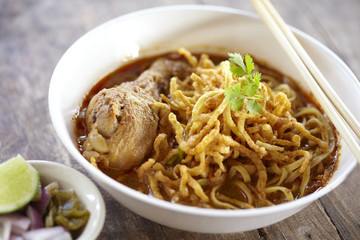 spicy chicken noodle on wooden table