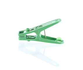 green plastic cloth peg and reflection