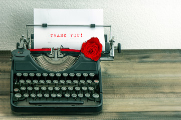 Fototapeta na wymiar vintage typewriter with paper page and rose flower