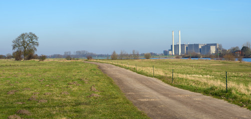 Fototapeta na wymiar Power plant along a river in winter