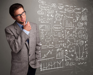 Attractive man looking at stock market graphs and symbols