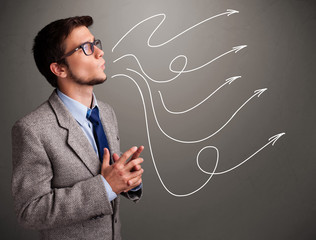 Attractive man looking at multiple curly arrows