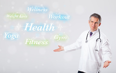 Clinical doctor pointing to health and fitness collection of wor