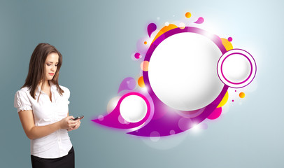 Pretty woman holding a phone and presenting abstract speech bubb