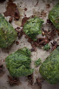 spinach plum cake and anise on spotted paper