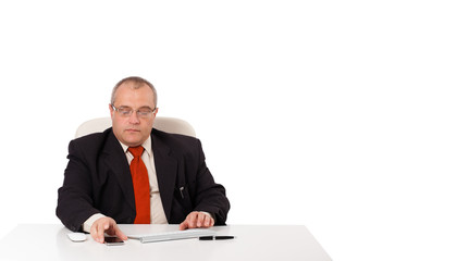 businessman sitting at desk and looking mobilephone with copyspa