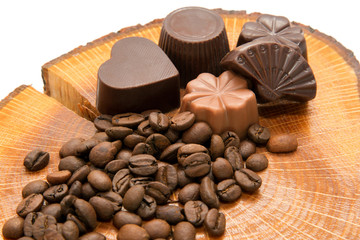 Coffee beans and chocolate candies on the stump
