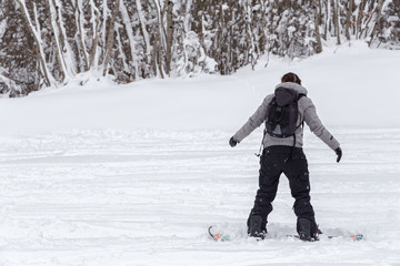 Fototapeta na wymiar Freeriding of a female snowboarder with copy space.