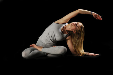 Fototapeta na wymiar Beautiful young woman in great shape practicing yoga